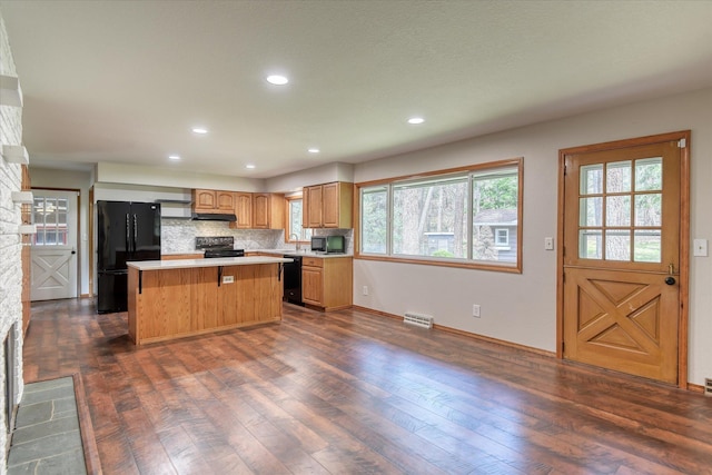 17614 N Palomino Rd, Colbert, WA 99005 - kitchen with black appliances, a center island, dark wood-style flooring, light countertops, and plenty of natural light