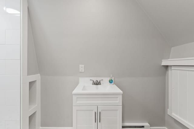 4053 Hanleys Hvn, Loon Lake, WA 99148 - bathroom with baseboard heating, vanity, and lofted ceiling