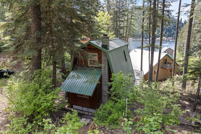 4053 Hanleys Hvn, Loon Lake, WA 99148 - view of side of property with metal roof, a chimney, and a water view