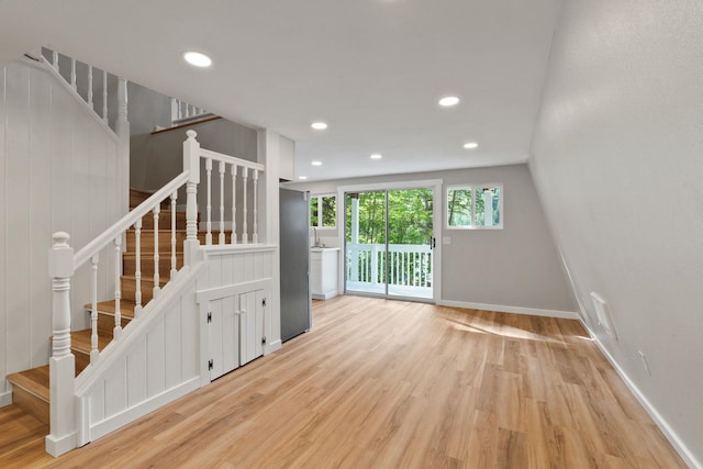 4053 Hanleys Hvn, Loon Lake, WA 99148 - unfurnished living room featuring wood finished floors, stairway, baseboards, and recessed lighting