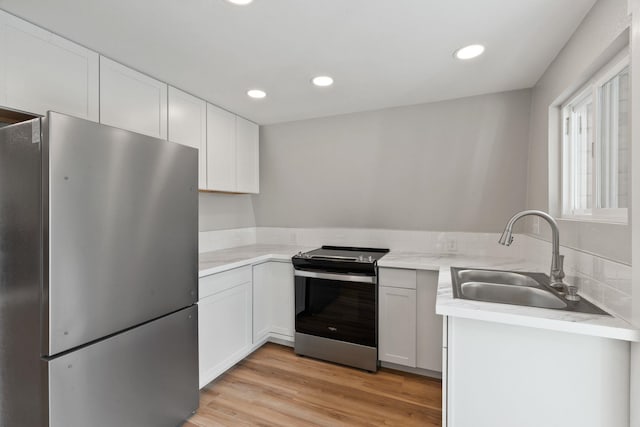 4053 Hanleys Hvn, Loon Lake, WA 99148 - kitchen featuring stainless steel appliances, a sink, white cabinetry, light countertops, and recessed lighting