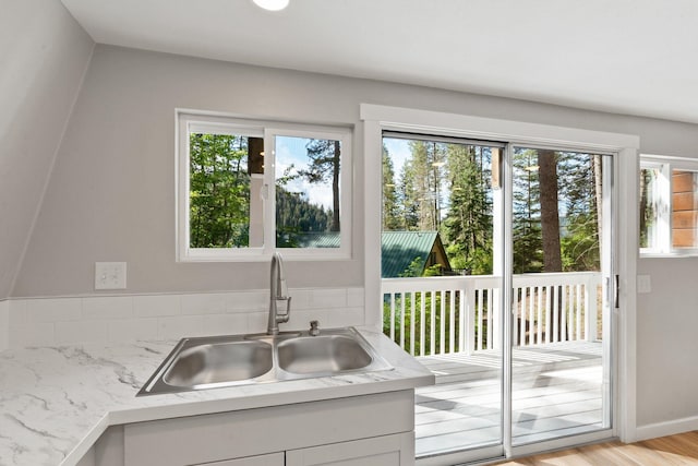 4053 Hanleys Hvn, Loon Lake, WA 99148 - kitchen featuring a sink, light wood-type flooring, and white cabinetry