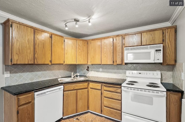 6015 E 6th Ave Apt N2, Spokane Valley, WA 99212 - kitchen featuring white appliances, a sink, decorative backsplash, crown molding, and a textured ceiling