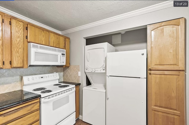 6015 E 6th Ave Apt N2, Spokane Valley, WA 99212 - kitchen featuring white appliances, stacked washer / dryer, a textured ceiling, ornamental molding, and backsplash