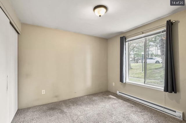 6015 E 6th Ave Apt N2, Spokane Valley, WA 99212 - unfurnished bedroom featuring a baseboard heating unit, multiple windows, carpet floors, and a closet