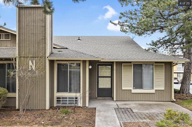 6015 E 6th Ave Apt N2, Spokane Valley, WA 99212 - view of front of property featuring roof with shingles, a chimney, and a patio