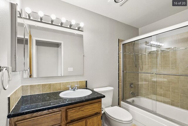 6015 E 6th Ave Apt N2, Spokane Valley, WA 99212 - kitchen featuring white appliances, a sink, stacked washer / drying machine, dark countertops, and ornamental molding