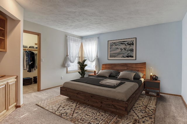 3023 S Winthrop Ln, Spokane, WA 99203 - carpeted bedroom featuring a walk in closet, a textured ceiling, baseboards, and a closet