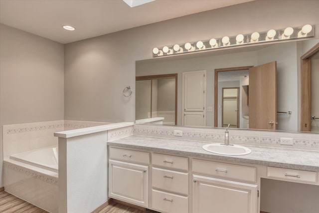 3023 S Winthrop Ln, Spokane, WA 99203 - bathroom with a bath, vanity, and wood finished floors