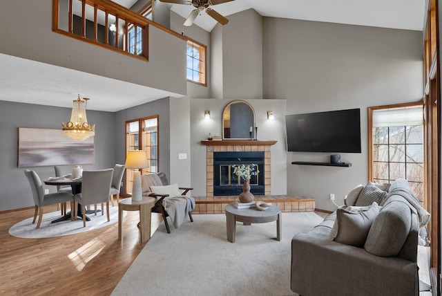2311 S Mamer Ct, Spokane Valley, WA 99216 - living room with wood finished floors, healthy amount of natural light, a chandelier, a ceiling fan, and high vaulted ceiling