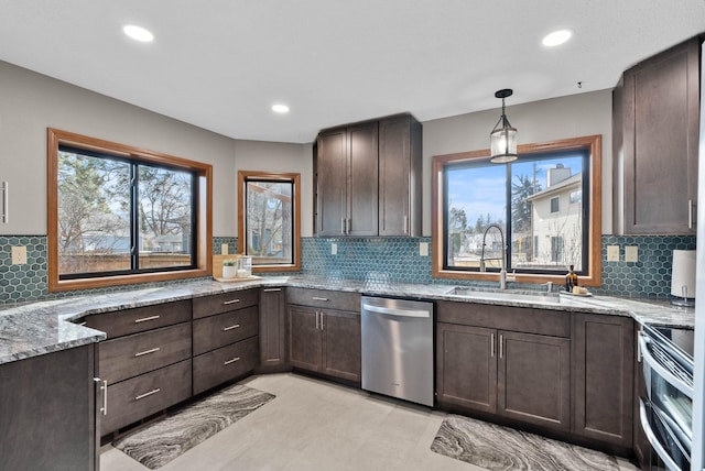 2311 S Mamer Ct, Spokane Valley, WA 99216 - kitchen featuring appliances with stainless steel finishes, a sink, dark brown cabinets, light stone counters, and recessed lighting