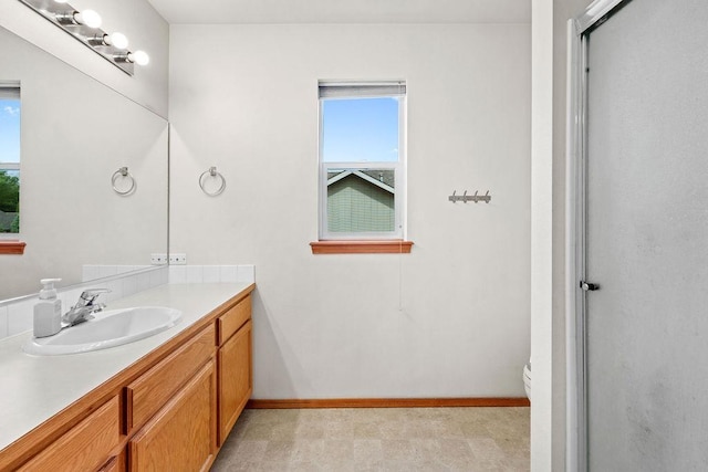 6831 N Cambridge Ln, Spokane, WA 99208 - bathroom featuring plenty of natural light, vanity, toilet, and a shower with shower door