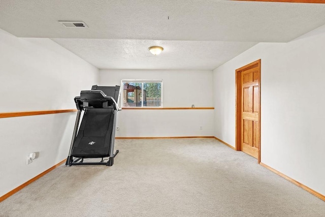 6831 N Cambridge Ln, Spokane, WA 99208 - exercise room featuring carpet, baseboards, and a textured ceiling