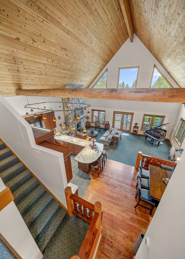 16010 W Jade Ln, Medical Lake, WA 99022 - living area featuring high vaulted ceiling, wood finished floors, and wooden ceiling with exposed beams