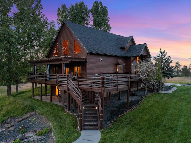 16010 W Jade Ln, Medical Lake, WA 99022 - view of front of home with stairway, a wooden deck, a shingled roof, a yard, and a patio