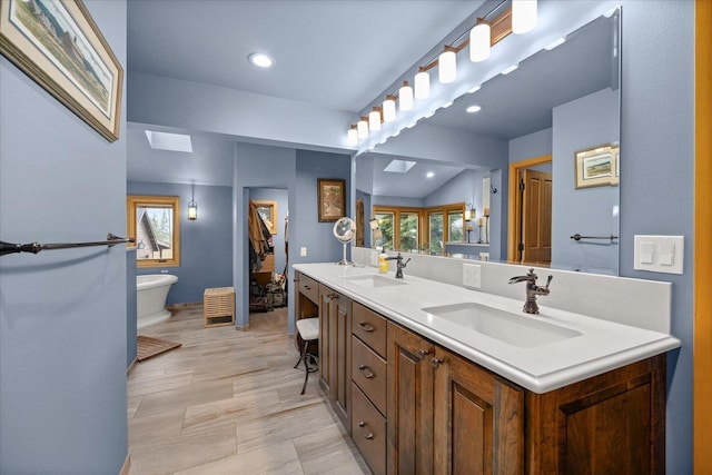 16010 W Jade Ln, Medical Lake, WA 99022 - bathroom with double vanity, a freestanding tub, healthy amount of natural light, and recessed lighting