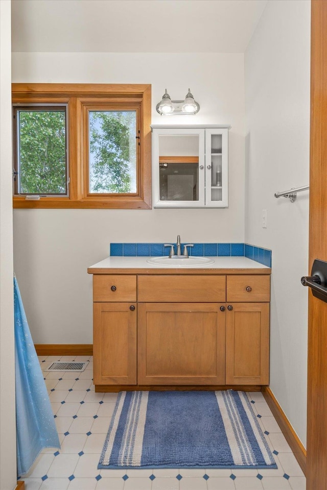 16010 W Jade Ln, Medical Lake, WA 99022 - bathroom with plenty of natural light, vanity, baseboards, and tile patterned floors