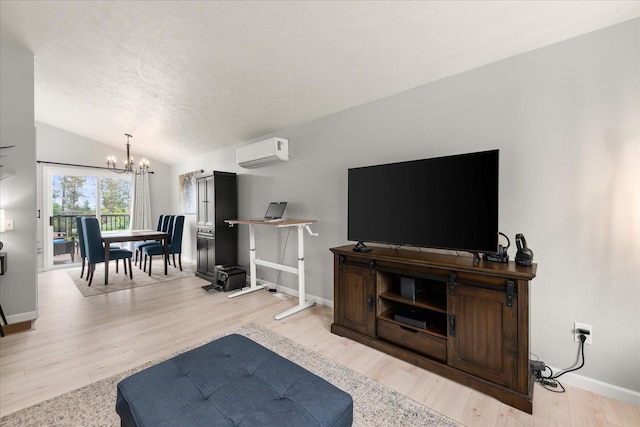 3815 E 19th Ave, Spokane, WA 99223 - living area with a wall mounted AC, a chandelier, baseboards, lofted ceiling, and wood finished floors