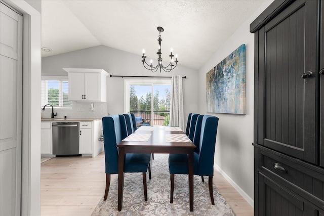 3815 E 19th Ave, Spokane, WA 99223 - dining room featuring light wood-type flooring, a chandelier, and vaulted ceiling