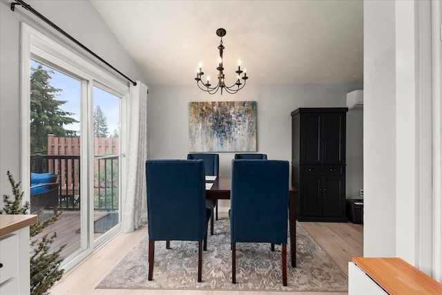 3815 E 19th Ave, Spokane, WA 99223 - dining room featuring light wood-style flooring, a chandelier, and an AC wall unit