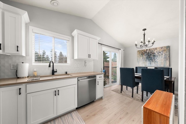 3815 E 19th Ave, Spokane, WA 99223 - kitchen featuring stainless steel dishwasher, a chandelier, light wood-type flooring, vaulted ceiling, and a sink