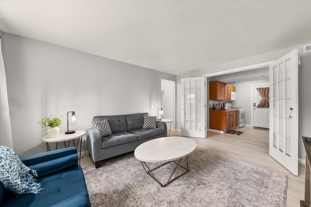 3815 E 19th Ave, Spokane, WA 99223 - living room with light wood finished floors, french doors, and baseboards