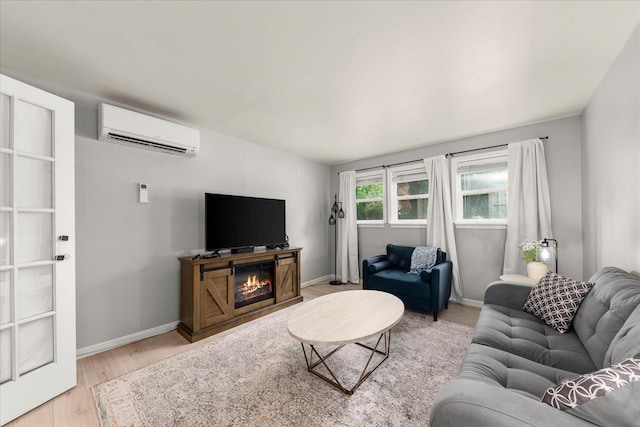 3815 E 19th Ave, Spokane, WA 99223 - living area with a wall mounted AC, light wood-style floors, and baseboards