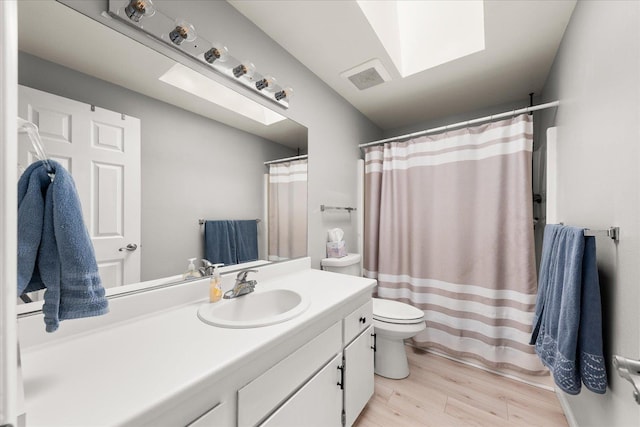 3815 E 19th Ave, Spokane, WA 99223 - bathroom featuring toilet, vanity, wood finished floors, and a shower with shower curtain