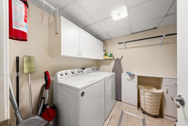 3815 E 19th Ave, Spokane, WA 99223 - laundry area featuring cabinet space, washing machine and clothes dryer, and light tile patterned floors