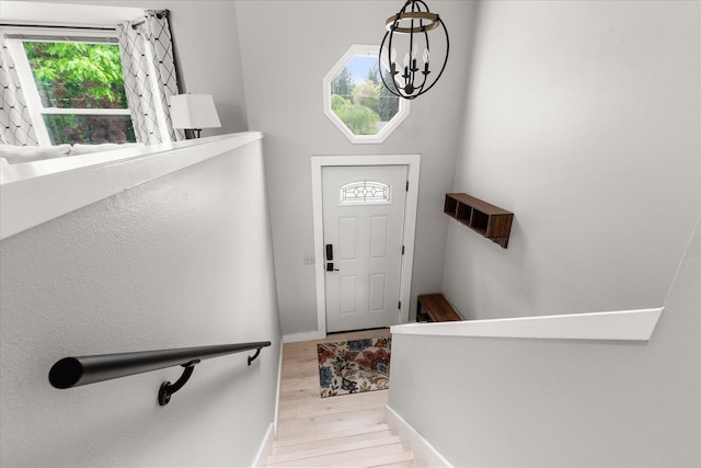 3815 E 19th Ave, Spokane, WA 99223 - foyer with light wood-type flooring, a chandelier, and baseboards