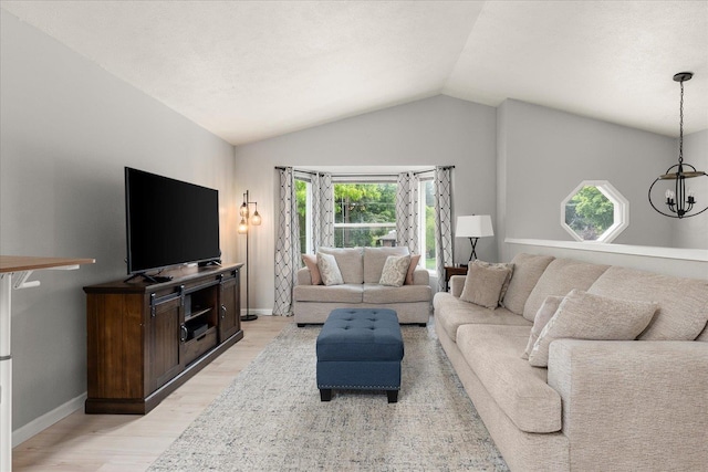 3815 E 19th Ave, Spokane, WA 99223 - living room with light wood finished floors, a chandelier, vaulted ceiling, and baseboards