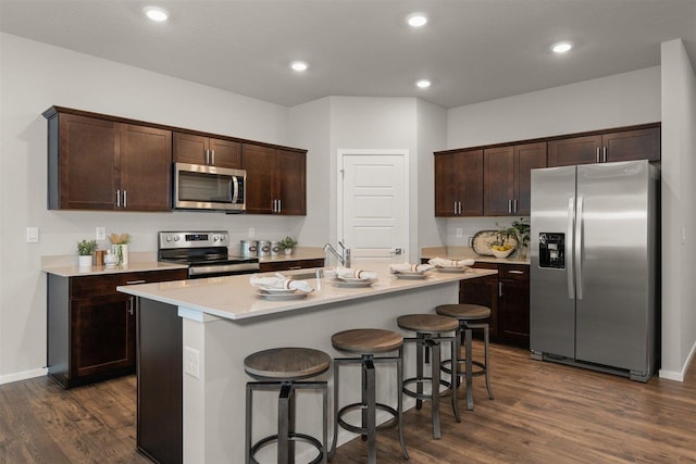 3719 S Keller Ln, Spokane Valley, WA 99206 - kitchen featuring stainless steel appliances, dark wood-style floors, dark brown cabinets, a breakfast bar, and recessed lighting