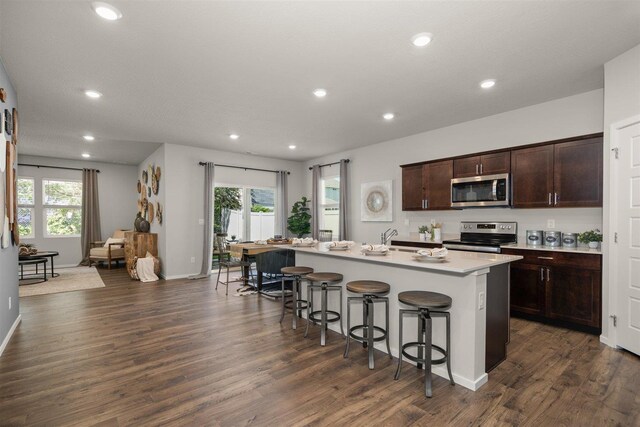 3719 S Keller Ln, Spokane Valley, WA 99206 - kitchen featuring stainless steel appliances, a breakfast bar area, plenty of natural light, dark wood finished floors, and recessed lighting