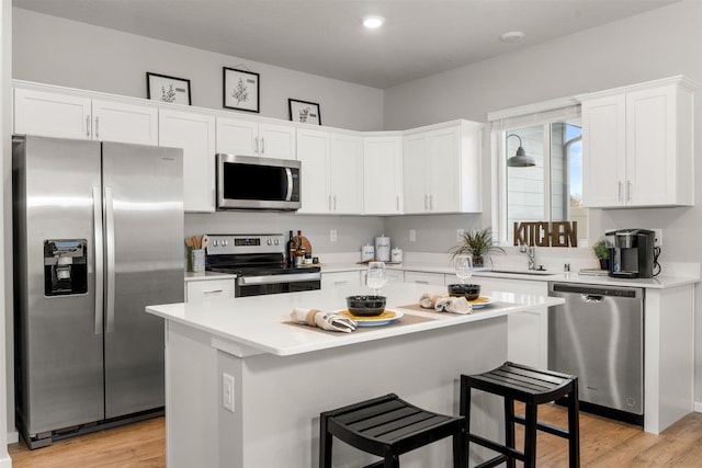 3286 N Glenrose Rd, Spokane, WA 99217 - kitchen with appliances with stainless steel finishes, white cabinets, a center island, light countertops, and recessed lighting