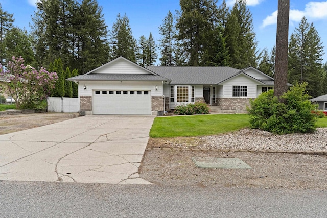 525 Quail Loop, Newport, WA 99156 - single story home with a garage, brick siding, concrete driveway, and a front lawn