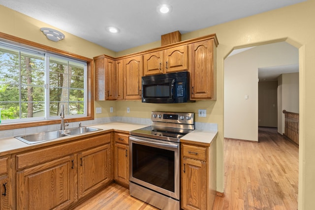 525 Quail Loop, Newport, WA 99156 - kitchen with electric range, black microwave, a sink, light countertops, and recessed lighting