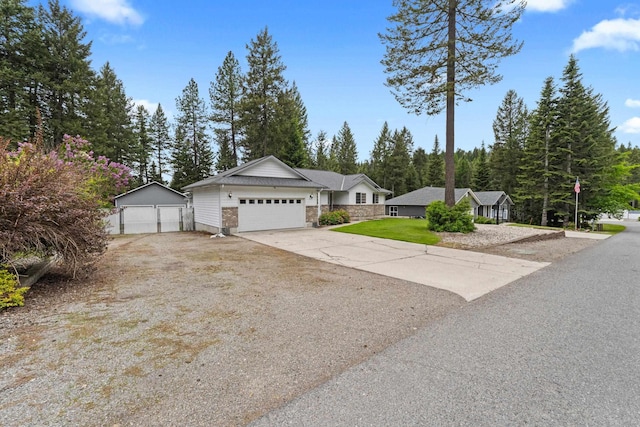 525 Quail Loop, Newport, WA 99156 - ranch-style house featuring a detached garage, stone siding, and a front lawn