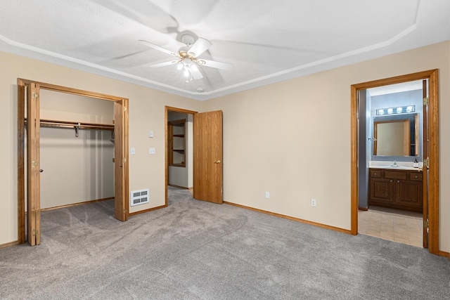 525 Quail Loop, Newport, WA 99156 - unfurnished bedroom featuring light colored carpet, a sink, baseboards, ensuite bath, and a ceiling fan