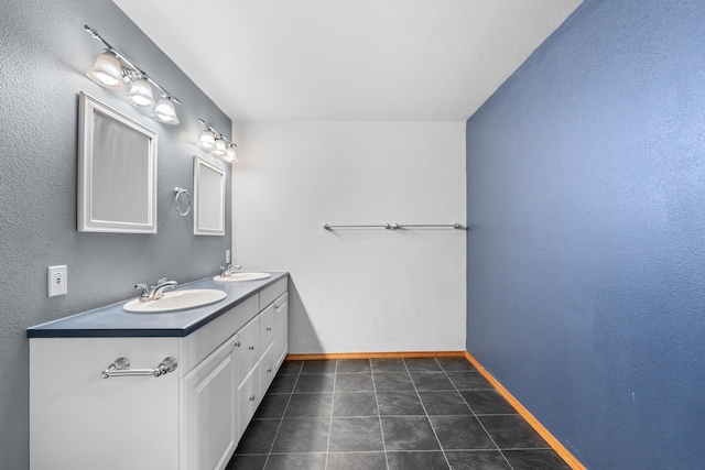525 Quail Loop, Newport, WA 99156 - bathroom featuring double vanity, baseboards, and tile patterned flooring