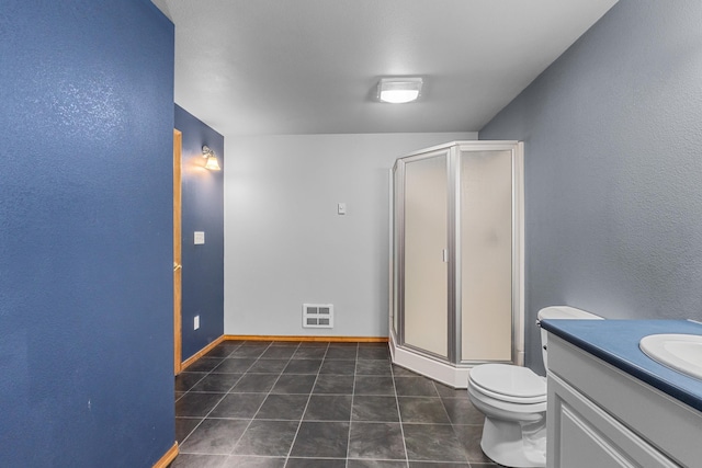 525 Quail Loop, Newport, WA 99156 - full bathroom with a stall shower, vanity, toilet, and tile patterned flooring