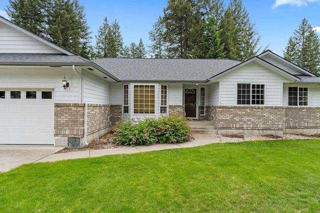 525 Quail Loop, Newport, WA 99156 - ranch-style home featuring brick siding, a garage, and a front lawn