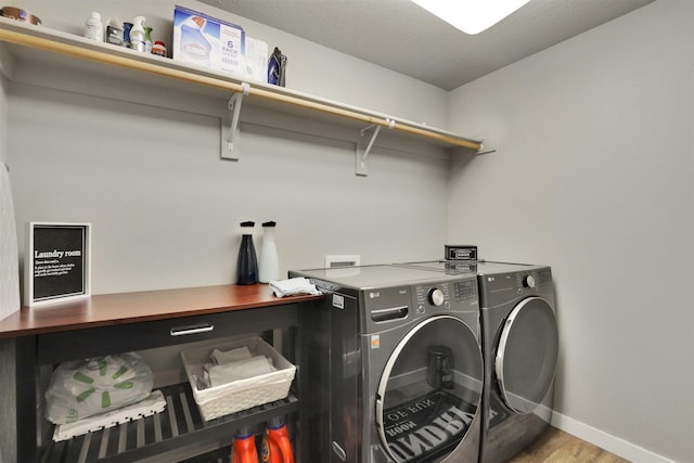 1105 S Oswald St, Spokane, WA 99224 - washroom featuring washer and dryer, baseboards, and wood finished floors