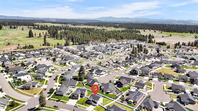1105 S Oswald St, Spokane, WA 99224 - aerial view of property's location featuring a mountainous background, a forest, and nearby suburban area
