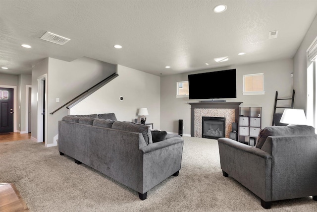 1105 S Oswald St, Spokane, WA 99224 - living area featuring light carpet, recessed lighting, a fireplace, baseboards, and a textured ceiling