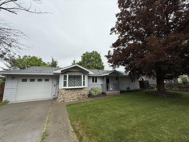 220 W Evergreen Dr, Kettle Falls, WA 99141 - ranch-style house with an attached garage, driveway, a front lawn, stone siding, and a shingled roof