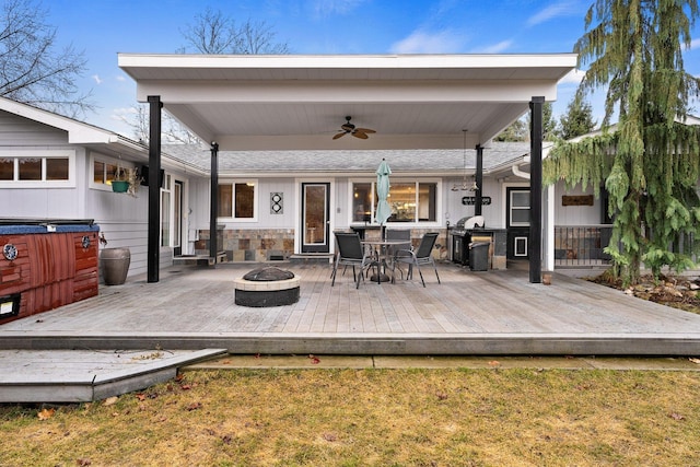 220 W Evergreen Dr, Kettle Falls, WA 99141 - wooden deck featuring an outdoor fire pit, ceiling fan, outdoor dining area, and a yard