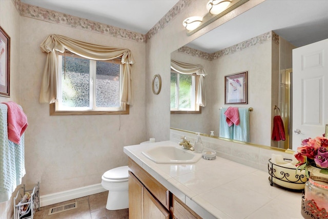 2205 S Conklin Rd, Spokane Valley, WA 99037 - full bathroom featuring toilet, vanity, baseboards, a shower with shower door, and tile patterned flooring