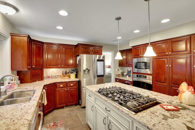 2205 S Conklin Rd, Spokane Valley, WA 99037 - kitchen featuring appliances with stainless steel finishes, a sink, decorative light fixtures, recessed lighting, and light stone counters