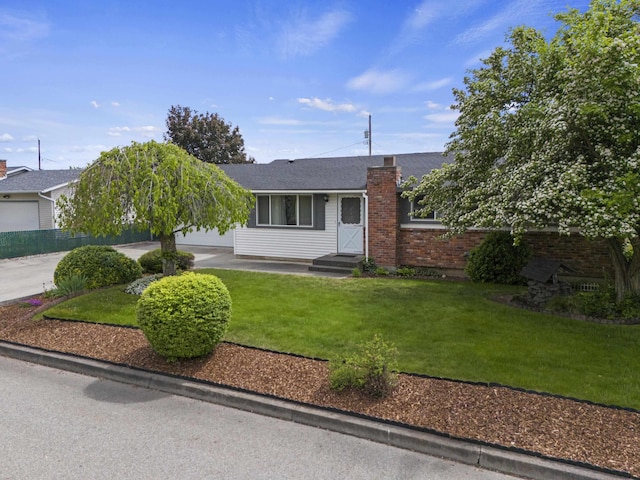 13304 E Desmet Ave, Spokane Valley, WA 99216 - view of front of house featuring a front yard, a chimney, and driveway