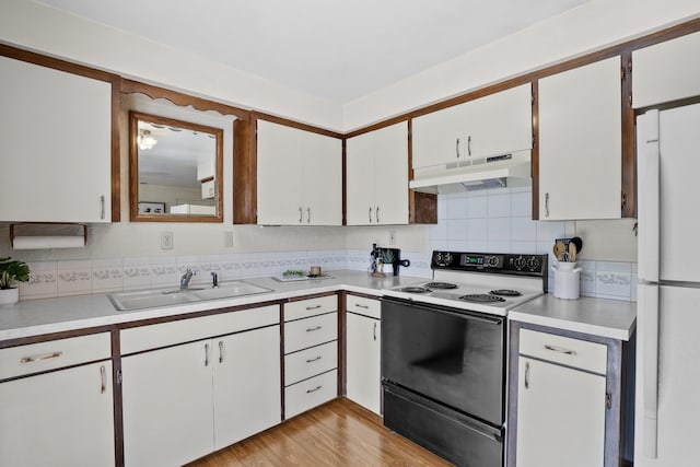 13304 E Desmet Ave, Spokane Valley, WA 99216 - kitchen featuring electric stove, under cabinet range hood, a sink, freestanding refrigerator, and light countertops